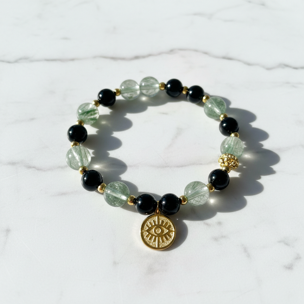 Black Obsidian & Green Phantom Wealth Bracelet with Gold Protection Crystal on white marble